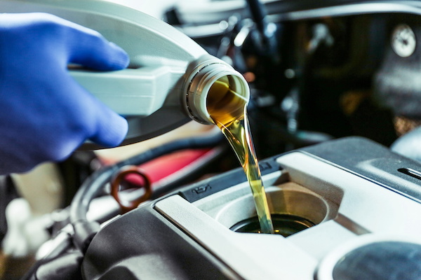 Mechanic performing an engine oil change for car maintenance | Prestige Auto Works in Sacramento